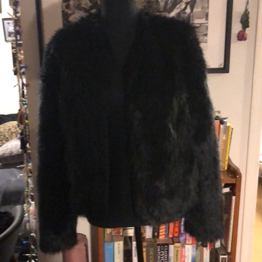 This lovely faux fur coat is a sleek black w/ a purple lining💜.